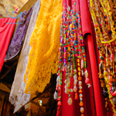 An image capturing a bustling Middle Eastern marketplace; vibrant colors of silk scarves and intricate mosaic patterns adorn the bustling stalls, while locals in traditional attire engage in warm, respectful interactions